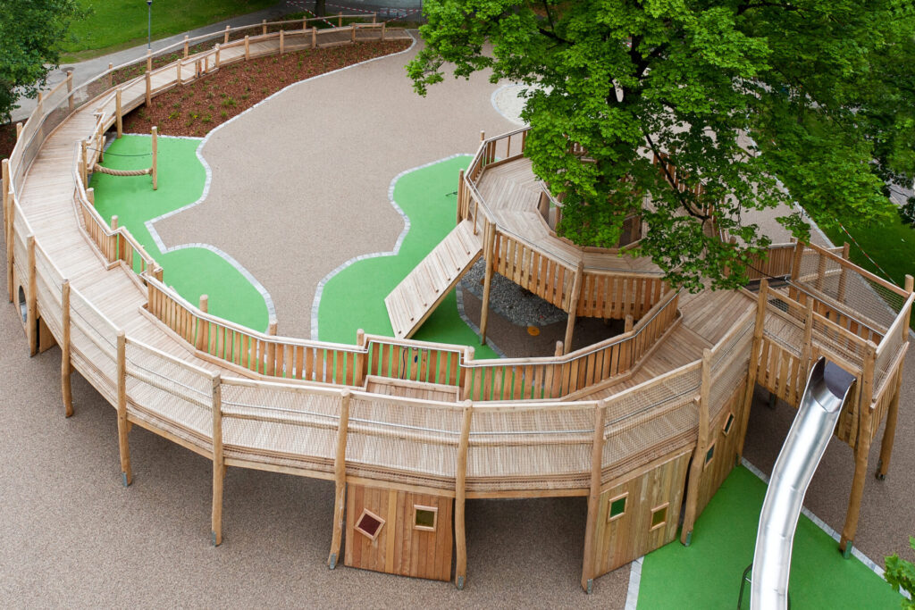 Spielrampe aus Holz, verschiedenfarbiger Bodenbelag, Luftaufnahme